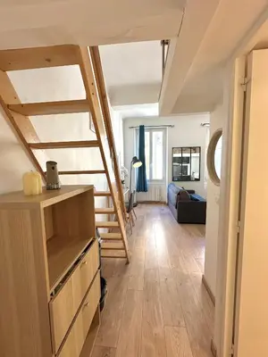 a living room with stairs and a room with a couch at Le Bleu Salonais - Centre ville in Salon-de-Provence
