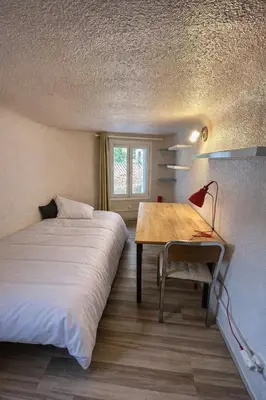 a bedroom with a bed and a desk and a table at Chambre Centre Aix Salle de Bain privée in Aix-en-Provence