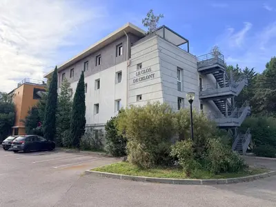 a building with a spiral staircase on the side of it at Le Clos d'AIX studio 205 in Aix-en-Provence