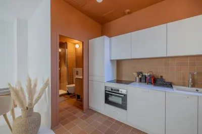 a kitchen with white cabinets and a sink at Appartement Belle Lettre 8 in Aix-en-Provence
