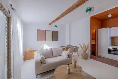 a living room with a couch and a table at Appartement Belle Lettre 8 in Aix-en-Provence