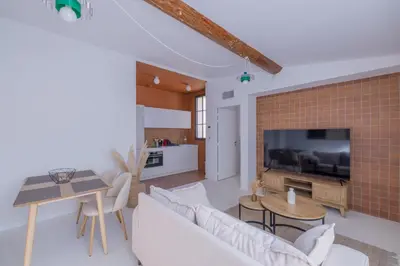 a living room with a couch and a tv at Appartement Belle Lettre 8 in Aix-en-Provence