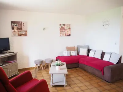 a living room with a red couch and a tv at Holiday Home in Provence near Mont Ventoux in Bédoin
