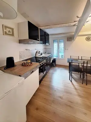 a kitchen and dining room with a table in it at L'olivade in La Fare-les-Oliviers