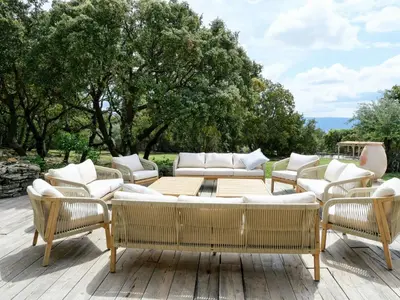 a group of chairs and couches on a patio at Stunning Stone House With Pool Near Gordes in Gordes
