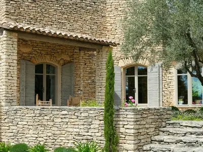 a stone house with two windows and a stone wall at Stunning Stone House With Pool Near Gordes in Gordes