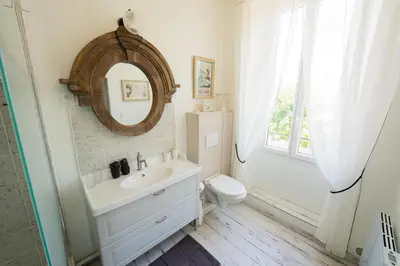 a bathroom with a sink and a toilet and a mirror at La Maison de Claire à Plan d'Orgon in Plan-dʼOrgon