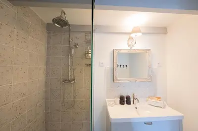 a bathroom with a shower and a sink and a mirror at La Maison de Claire à Plan d'Orgon in Plan-dʼOrgon