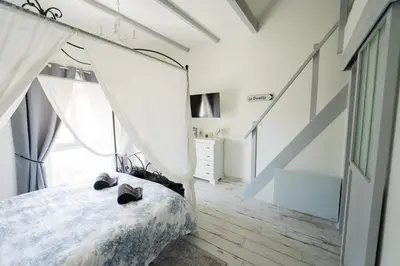 a bedroom with a bed with shoes on it at La Maison de Claire à Plan d'Orgon in Plan-dʼOrgon