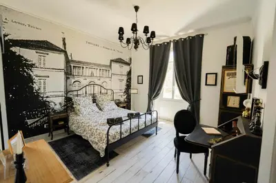 a bedroom with a bed with a drawing on the wall at La Maison de Claire à Plan d'Orgon in Plan-dʼOrgon