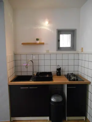 a kitchen with a sink and a counter top at Maison lumineuse proche du centre in Carpentras