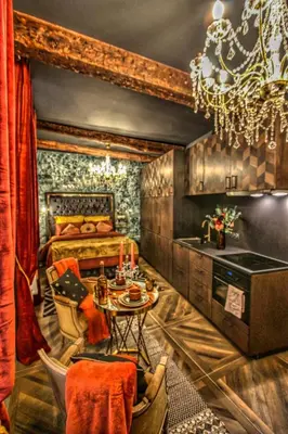 a bedroom with a bed and a table and a chandelier at Esmeralda centre historique in Aix-en-Provence