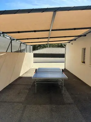 a ping pong table under awning on a skate park at Grande maison familiale tout confort in Éguilles