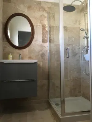 a bathroom with a shower with a sink and a mirror at Superbe appartement dans la Venise Provençale in LʼIsle-sur-la-Sorgue