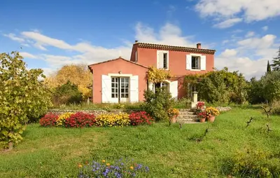a pink house with flowers in a yard at Pet Friendly Home In Gargas With Wifi in Gargas