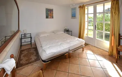 a bedroom with a bed and a large window at Pet Friendly Home In Gargas With Wifi in Gargas