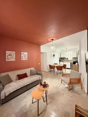 a living room with a couch and a table at Appartement de la flûte in LʼIsle-sur-la-Sorgue