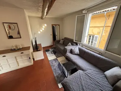 a bedroom with a bed and a mirror in it at Cozy apartment Aix-en-Provence city center in Aix-en-Provence