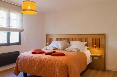 a bedroom with a bed with two pillows on it at La Maison De Paulette in Joucas