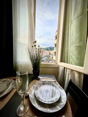 a table with a plate of food and a window at Studio lumineux au cœur du Luberon Parking gratui in Cavaillon