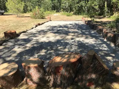 a road with logs on the side of it at studio à la campagne avec piscine in Peyrolles-en-Provence