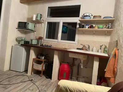 a kitchen with a counter and a sink and a window at studio à la campagne avec piscine in Peyrolles-en-Provence