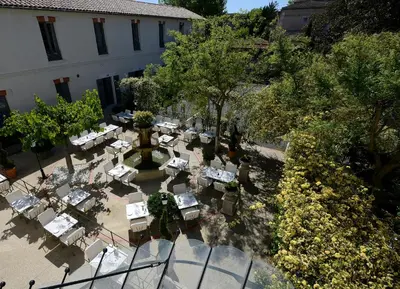 an overhead view of a restaurant with tables and trees at Grand Hôtel Henri - Teritoria in LʼIsle-sur-la-Sorgue
