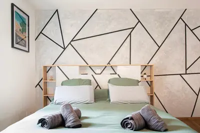 a bedroom with a bed with two towels on it at Studio Cosy au Cœur de la Ville in Salon-de-Provence