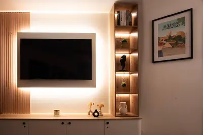 a living room with a television on a wall at Studio Cosy au Cœur de la Ville in Salon-de-Provence