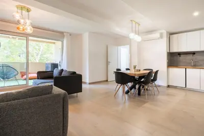 a living room with a table and a dining room at Le Casanelle in Aix-en-Provence
