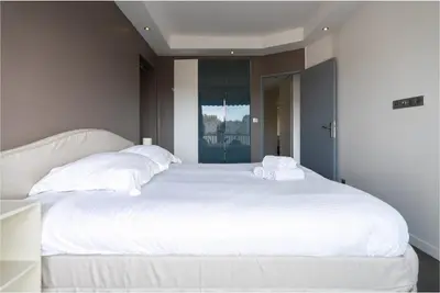 a large white bed with white sheets and pillows at The 42 in Aix-en-Provence