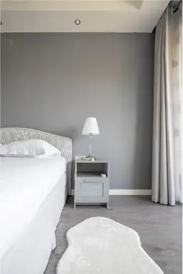 a bedroom with a bed and a table with a lamp at The 42 in Aix-en-Provence