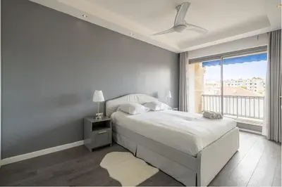 a white bedroom with a bed and a window at The 42 in Aix-en-Provence