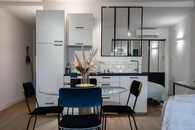 a kitchen with a table and chairs in a room at 2 rooms apartment in the city center in Aix-en-Provence