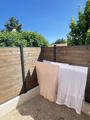 two white curtains are hanging on a fence at Terres de Durance in Charleval
