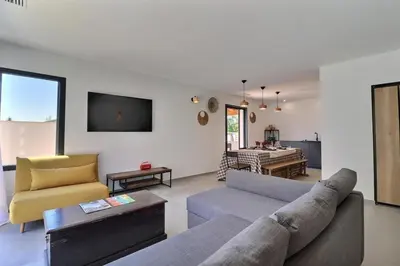 a living room with a couch and a table at Terres de Durance in Charleval