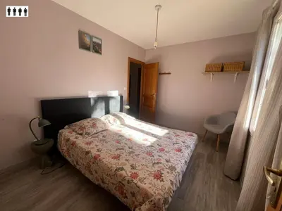 a bedroom with a bed and a chair in it at Gîte au Ventoux in Villes-sur-Auzon