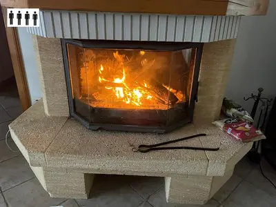 a fireplace with a fire inside of it at Gîte au Ventoux in Villes-sur-Auzon