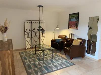 a living room with two chairs and a glass table at Gîte au Ventoux in Villes-sur-Auzon