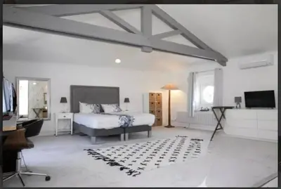 a bedroom with a bed and a television in it at CHATEAU 18e AVEC PISCINE in La Celle-sous-Gouzon