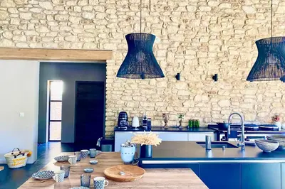 a kitchen with two pendant lights above a sink at House for rent in Ménerbes Villa Carpe Diem in Ménerbes