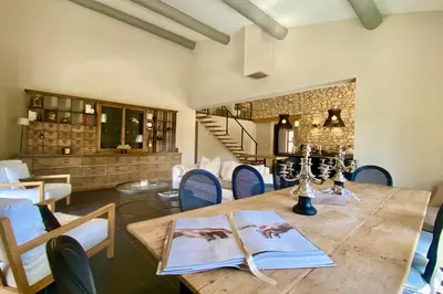 a dining room with a wooden table and chairs at House for rent in Ménerbes Villa Carpe Diem in Ménerbes