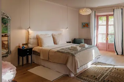 a bedroom with a bed and a pink door at Mas de La Lombarde Saint Rémy de Provence in Saint-Rémy-de-Provence
