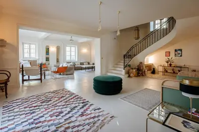 a large living room with a staircase and a living room at Mas de La Lombarde Saint Rémy de Provence in Saint-Rémy-de-Provence