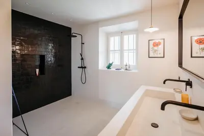 a bathroom with a bath tub and a shower at Mas de La Lombarde Saint Rémy de Provence in Saint-Rémy-de-Provence
