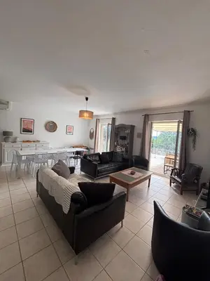 a living room with a couch and a table at Jolie maison avec piscine , proche du centre de Bédoin in Bédoin