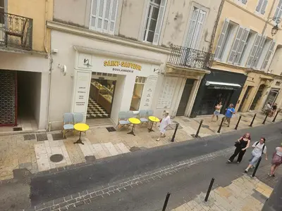 a group of people walking in front of a store at Charmant Appartement Aixois in Aix-en-Provence