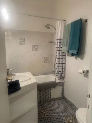 a bathroom with a sink and a tub and a toilet at Charmant Appartement Aixois in Aix-en-Provence