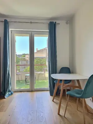 a room with a table and chairs and a sliding glass door at Studio centre Aix - Climatisé avec terrasse in Aix-en-Provence