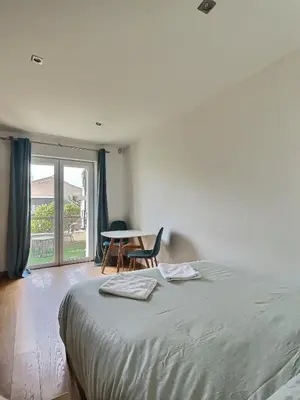 a bedroom with a bed and a table and a window at Studio centre Aix - Climatisé avec terrasse in Aix-en-Provence